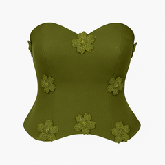 Green strapless top with floral embellishments on a white background